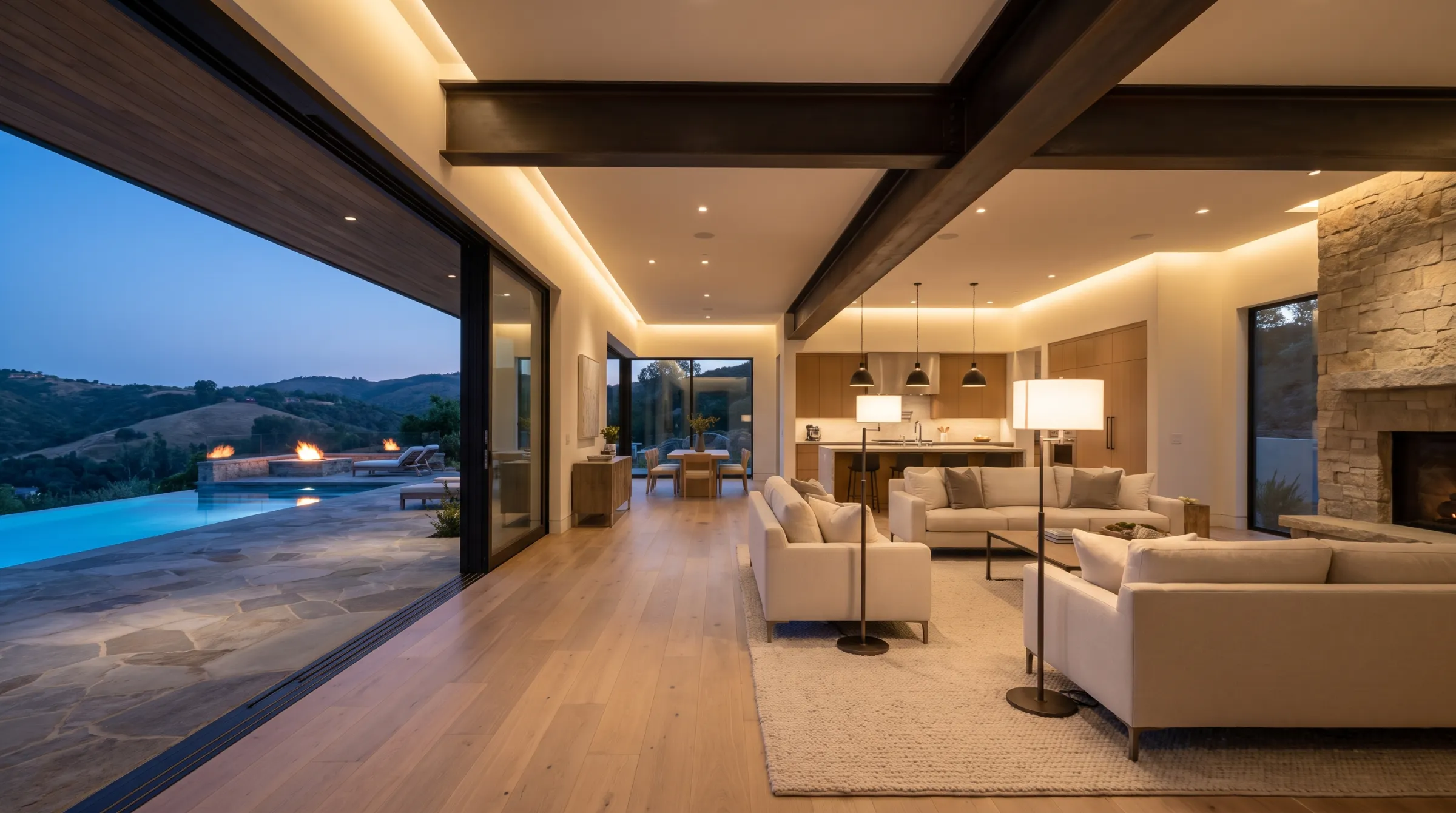 Open-concept living room with an exposed steel beam spanning where walls were removed